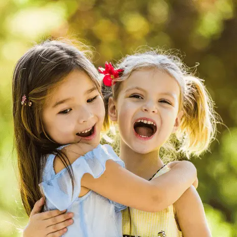 child holding sign at extraordinary kids