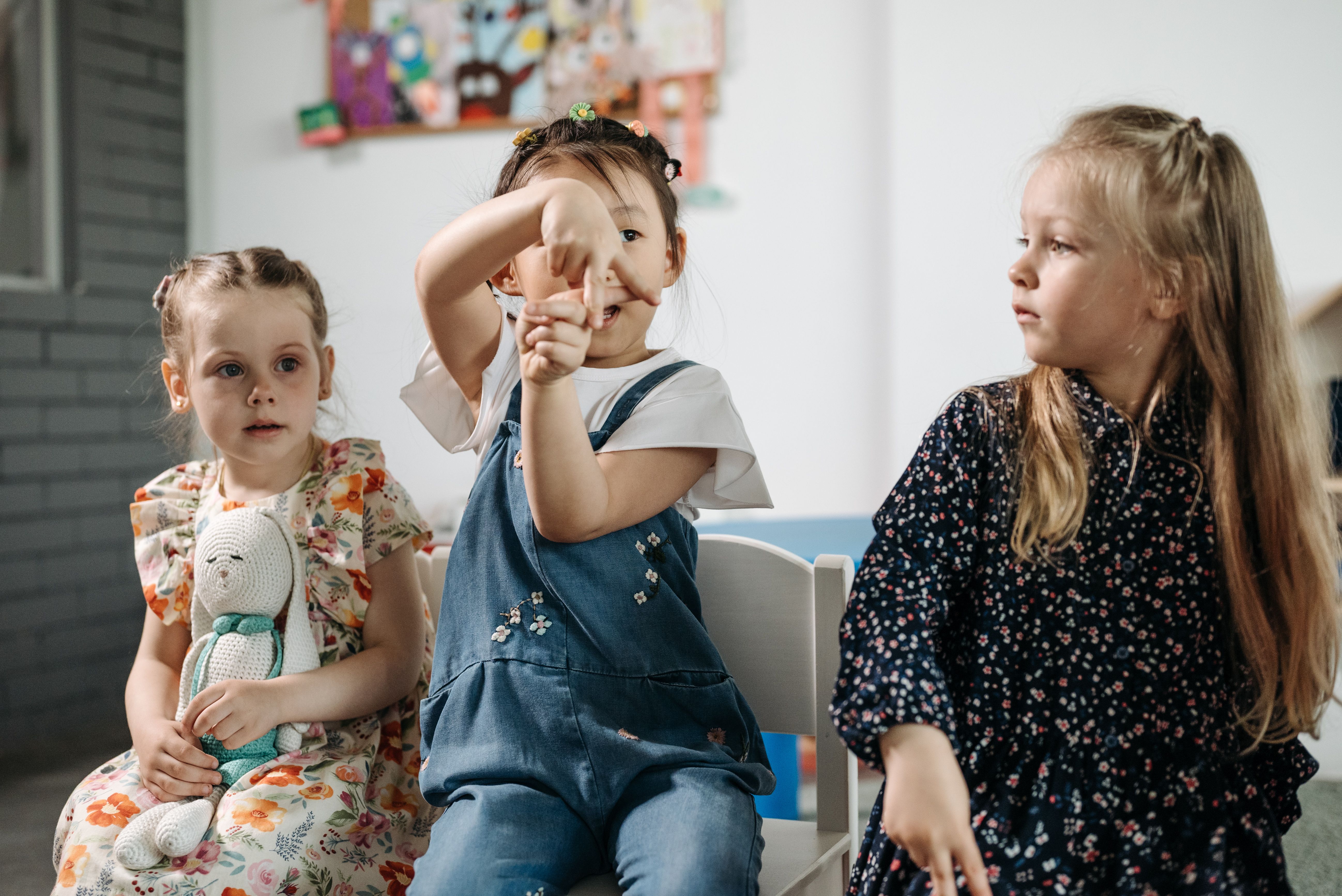 Three preschool children learning and playing together